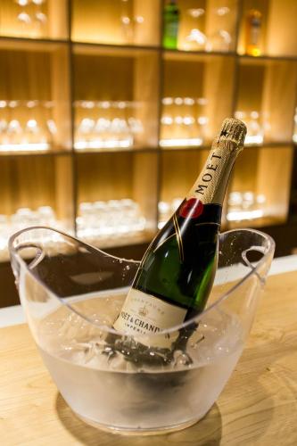 a bottle of champagne in a glass bowl on a table at The Gate Porto in Porto