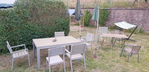 a group of chairs and tables and umbrellas at Art Apartment - Harz in Stolberg i. Harz