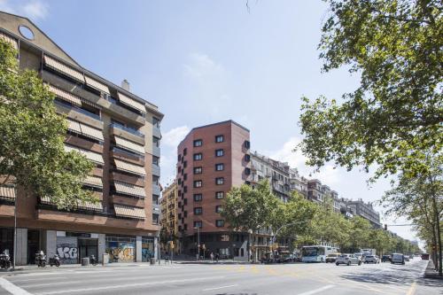 a city street with tall buildings and a road with cars at Hotel Brick Barcelona in Barcelona