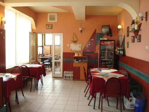 a restaurant with tables and chairs in a room at Pensiunea Marc in Suceava