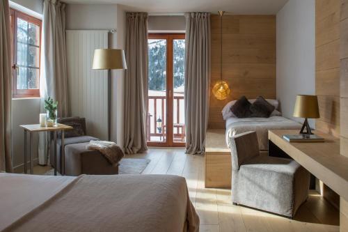 a hotel room with two beds and a balcony at Grau Roig Andorra Boutique Hotel & Spa in Grau roig