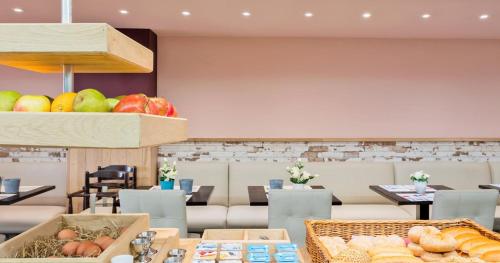 a bakery with bread and fruit on a table at Hotel De Zeebries Budget in Middelkerke