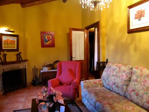 a living room with a couch and a chair at Apartamentos Rurales La Macera **** in Valencia de Alcántara