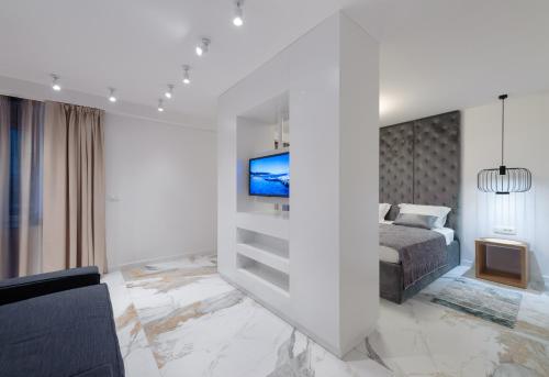 a bedroom with a bed and a tv on a wall at Royal Luxury Room in Split