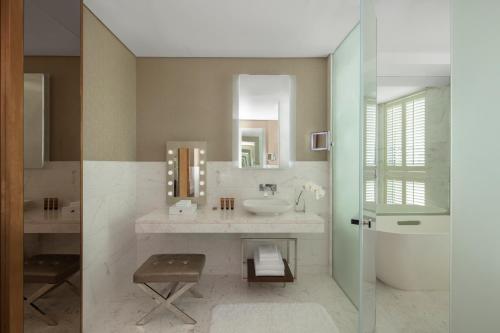 a bathroom with a sink and a mirror at Paramount Hotel Dubai in Dubai