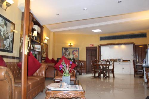 a living room with a couch and a table at Hotel Jukaso Inn Down Town in New Delhi