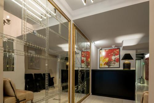 Cette chambre dispose de murs en verre, d'un canapé et d'une table. dans l'établissement Fos DownTown Suites, à Athènes