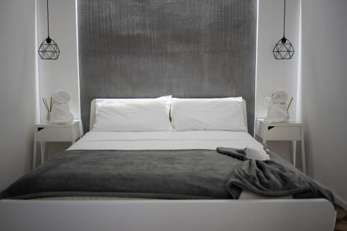 a bedroom with a bed and two night stands at Reusuite in Ragusa
