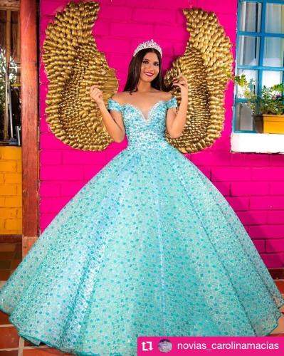 a woman in a blue dress in front of a pink wall at Dunas Tatacoa in Villavieja