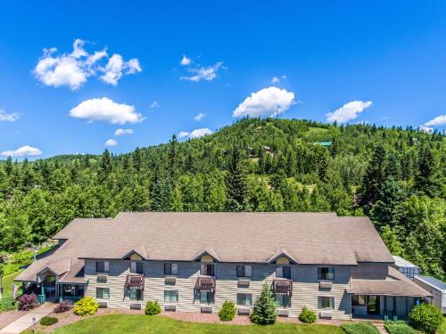an aerial view of a house with a mountain in the background at Mountain Inn at Lutsen in Lutsen