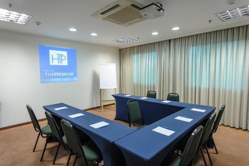 a conference room with a blue table and chairs at Hotel The Premium in Osasco
