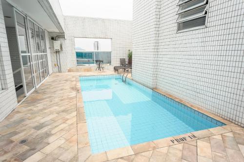 a swimming pool in the side of a house at Hotel The Premium in Osasco