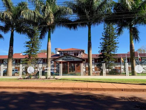 a building with palm trees in front of it at Hotel Staufenberg in Santa Rita