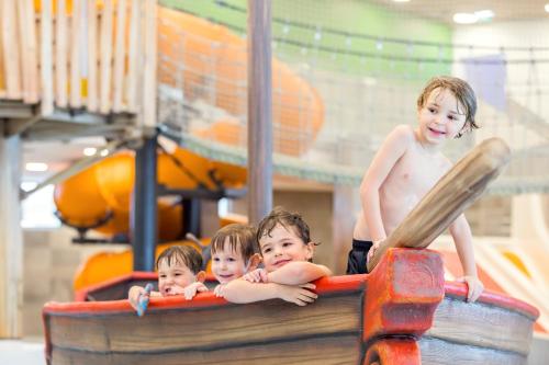 a group of three children playing on a playground at Zugspitz Resort in Ehrwald