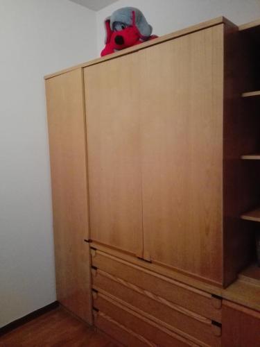 a stuffed animal is sitting on top of a cabinet at Affittacamere Nerio in Ronchi dei Legionari