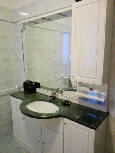 a bathroom with a sink and a mirror at Affittacamere Nerio in Ronchi dei Legionari