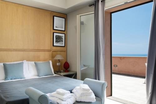 a bedroom with a bed and a sliding glass door at Torre Bonera. Green Resort in Menfi