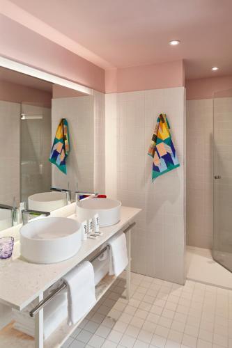 a bathroom with two sinks and a shower at Mama Shelter Lille in Lille