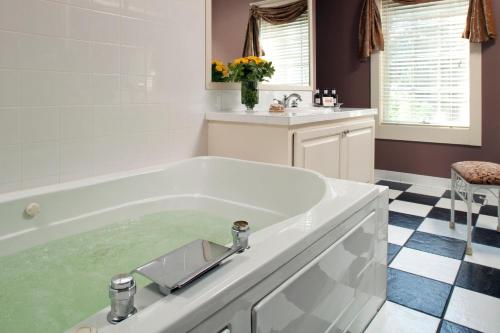 a bath tub filled with water in a bathroom at Fairview Inn in Jackson