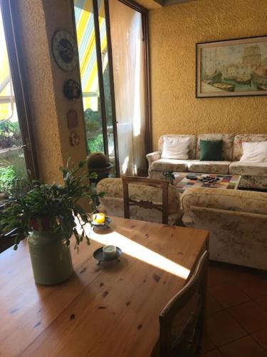 sala de estar con mesa de madera y sofá en Il Boscaccio, en Camaiore