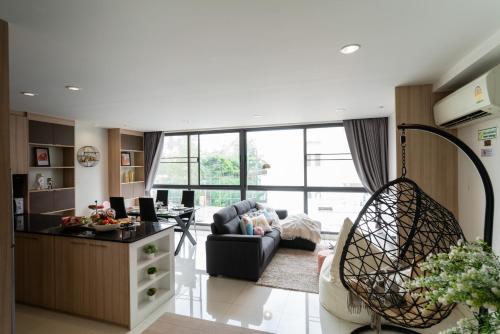 a living room with a couch and a chair at Prairie Villa in Bangkok