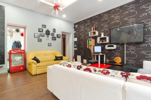a living room with a white couch and a tv at Pogo Hostel in Vilnius