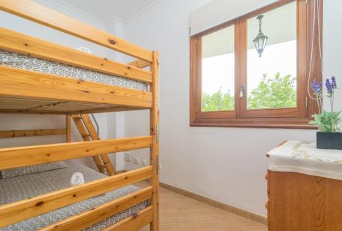 a room with a bunk bed and a window at CAN NADAL - ADULTS ONLY in Sineu