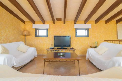 a living room with two beds and a flat screen tv at CAN NADAL - ADULTS ONLY in Sineu
