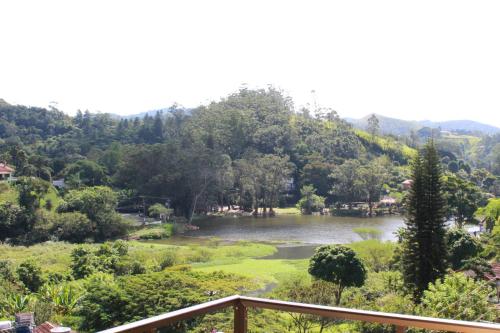 a view of a lake from a balcony at Morada Recanto das Flores in Miguel Pereira