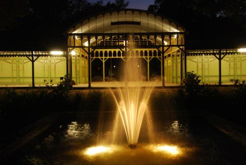 a fountain in front of a large building at night at Café Mandeltårtan B&B VillaFloraViola in Ronneby
