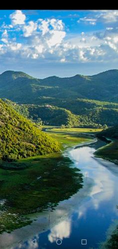 an aerial view of a river with mountains in the background at T&A Apartment in Rijeka Crnojevića