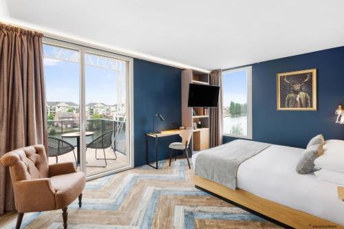 a hotel room with a bed and a large window at Aiden by Best Western T'aim Hotel & SPA in Compiègne