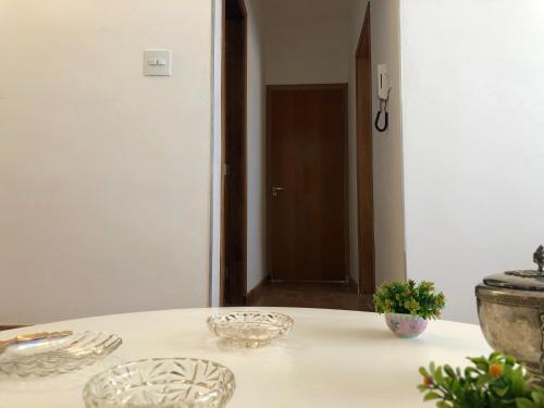 a white table with two plates on top of it at Pousada Monte Alegre in Sao Paulo