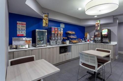 a fast food restaurant with two tables and a counter at Microtel Inn & Suites by Wyndham Bethel/Danbury in Bethel