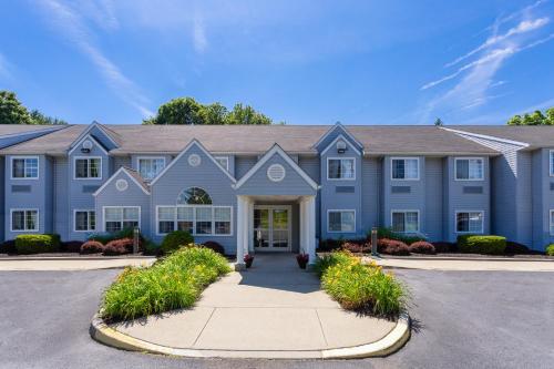 a large blue house with a driveway at Microtel Inn & Suites by Wyndham Bethel/Danbury in Bethel