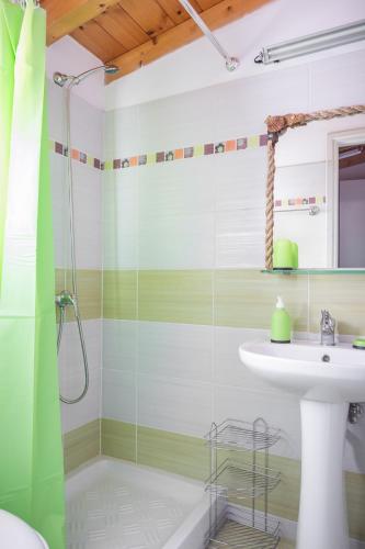 a bathroom with a sink and a shower at Elina's easygoing place in Mantoúkion