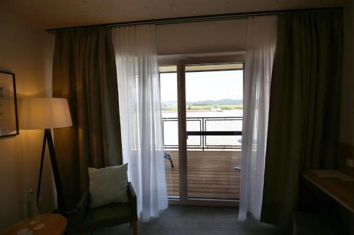a room with a door with a view of a balcony at Donau Lodge in Ybbs an der Donau