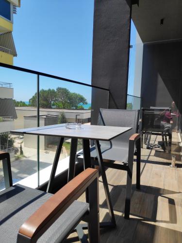 a table and chairs on the balcony of a building at Supreme Hotel in Golem
