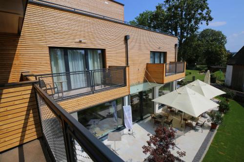 an outdoor patio with tables and umbrellas on a building at Donau Lodge in Ybbs an der Donau