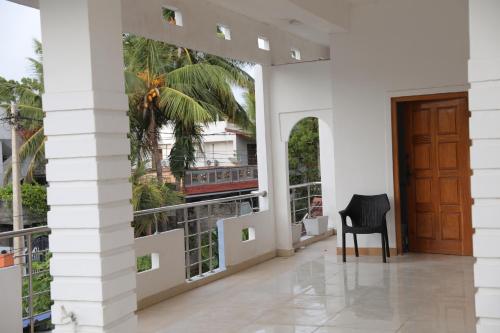 a room with a door and a chair in a building at Birunthavanam in Vavuniya