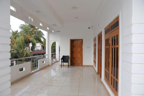 a hallway of a building with a door and a desk at Birunthavanam in Vavuniya