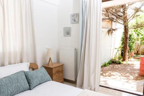 a bedroom with a bed and a large window at Apartment in Peania (15min from Airport) in Paianía