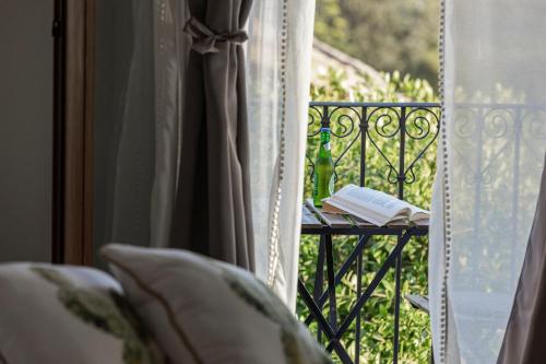 a book sitting on a table next to a window at B&B Dimora dei Templi in Agrigento