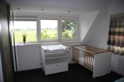 a baby room with a crib and a window at Ferienhaus Weitblick in Sint Maarten