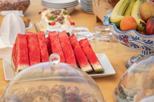 a table with a plate of fruit and a bowl of fruit at B&B Dimora dei Templi in Agrigento