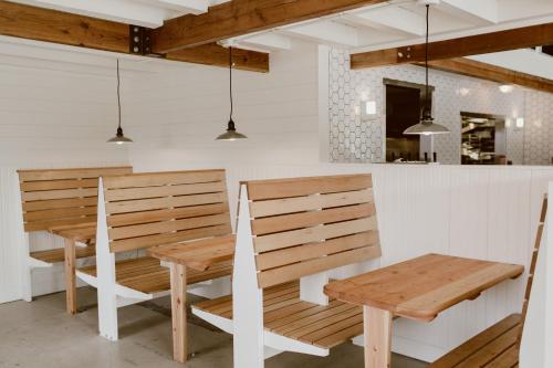 a kitchen with two wooden benches and a table at The Suttle Lodge & Boathouse in Camp Sherman