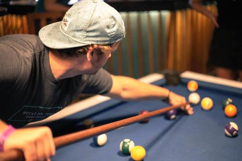 a man is playing a game of billiard at Dreamer Santa Marta in Santa Marta