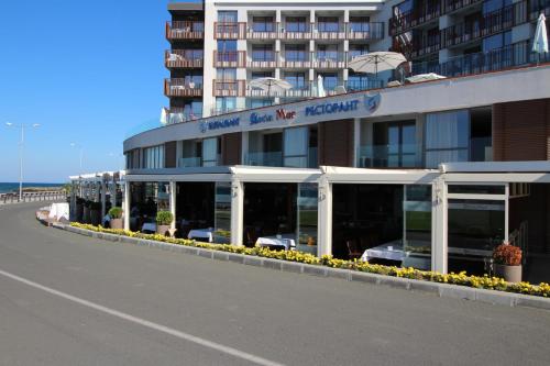a building with a row of windows on the side of a road at PARADISO 308-309 Private Studios Nessebar in Nesebar
