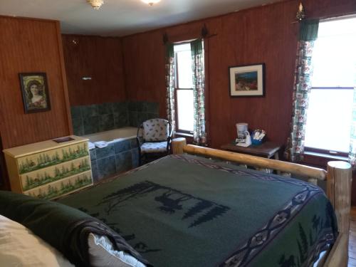 a bedroom with a bed and a bath tub at The Woods Inn in Inlet