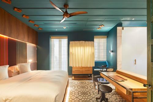 a bedroom with a bed, chair and a window at Hotel Boutique Casona del Colegio in Cartagena de Indias